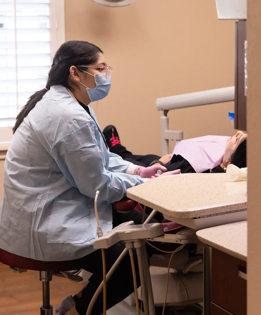 A team member seated beside a patient at Payne & King
